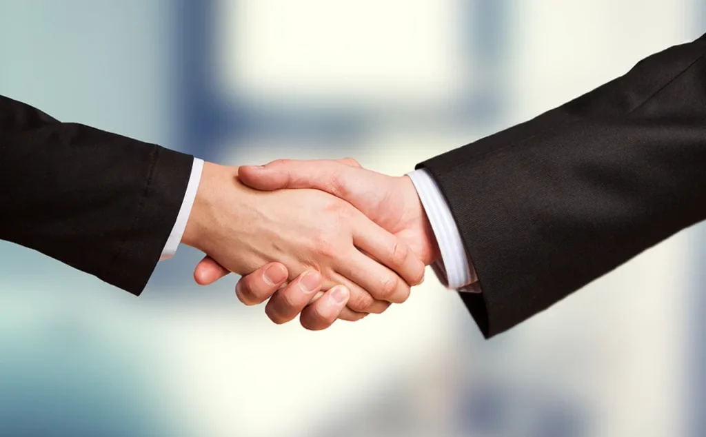 Image of a handshake, symbolizing a bilateral cooperation agreement between two countries.
