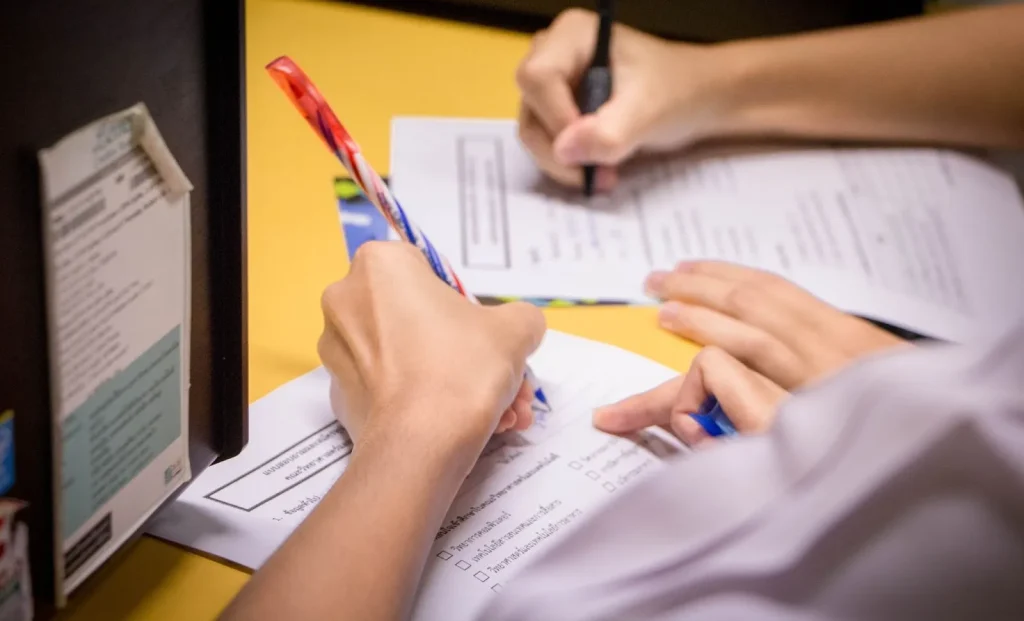 Image of a team reviewing documents, demonstrating the use of 'draft' in a business context.