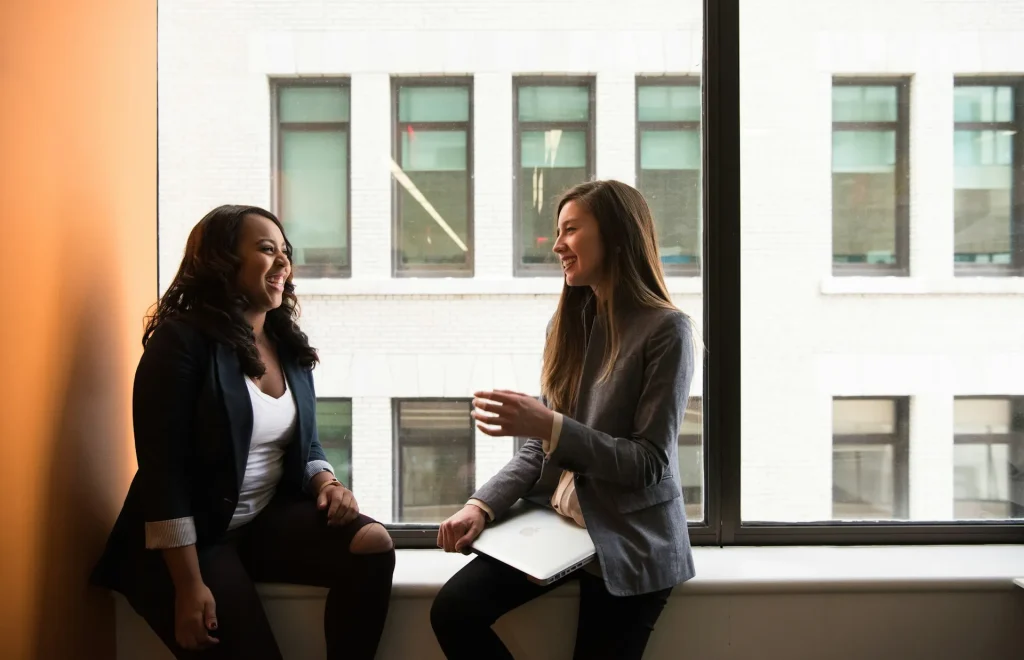 Image of two people discussing a mutually beneficial agreement, illustrating synonyms for 'win-win.'
