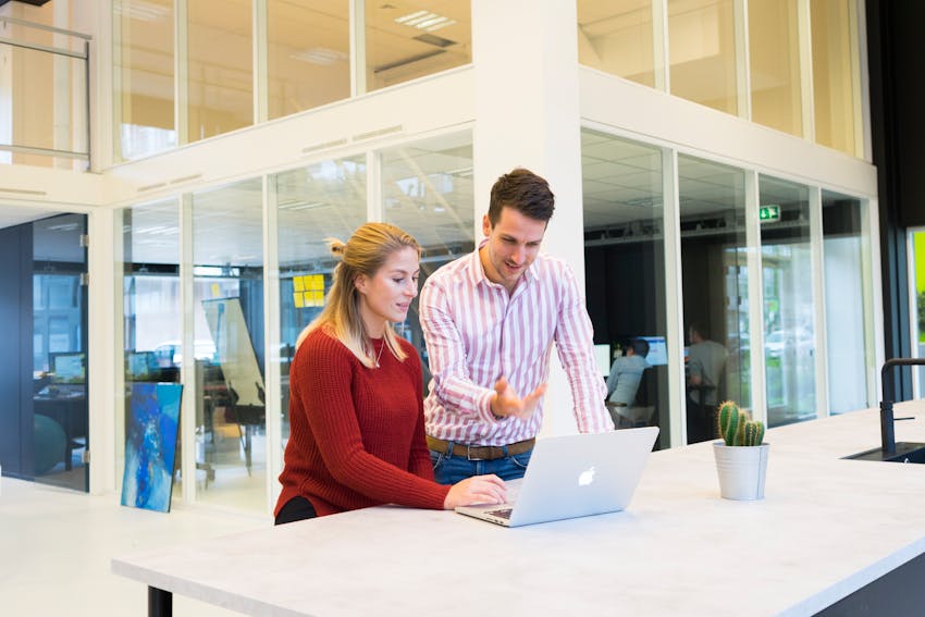 Image of a business mentor figure talking to a younger person, illustrating the concept of Shussebarai in a workplace context.