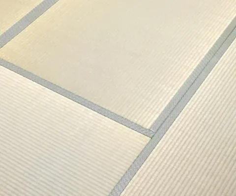 Close-up of a Tatami mat showing the woven rush surface and the fabric border (Heri).