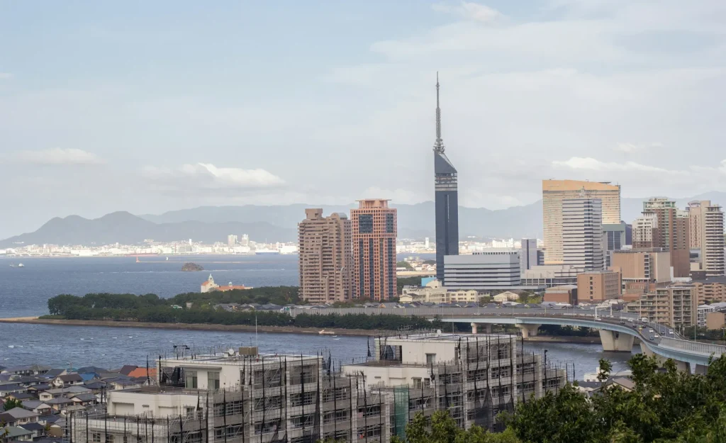 Image of the vibrant Fukuoka cityscape at night, symbolizing its role as a diverse hub.