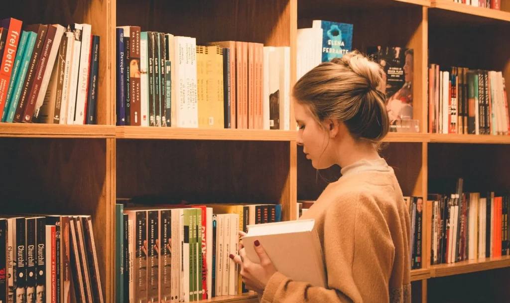 Image of a person using a library self-checkout machine in Japan.