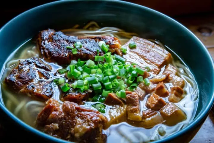 Image of a bowl of Sōki Soba (Okinawa soba with braised pork ribs).