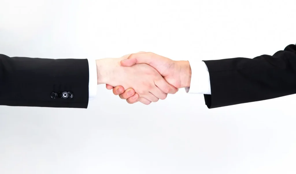 Image illustrating the polite or honorific use of 'Yoroshiku Onegaishimasu' in a business setting.