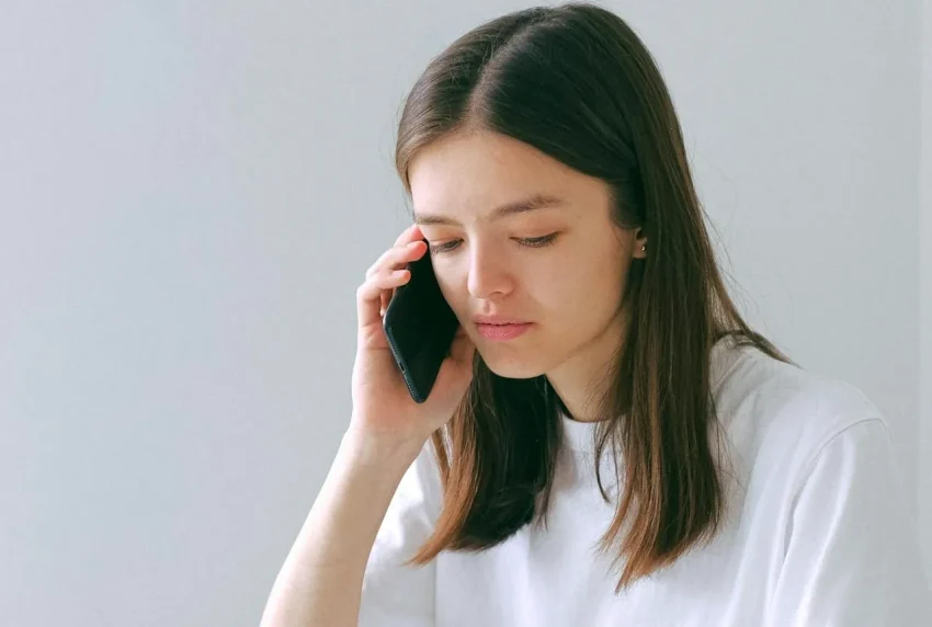 Image of a person on the phone to emergency services, listing key information to provide.