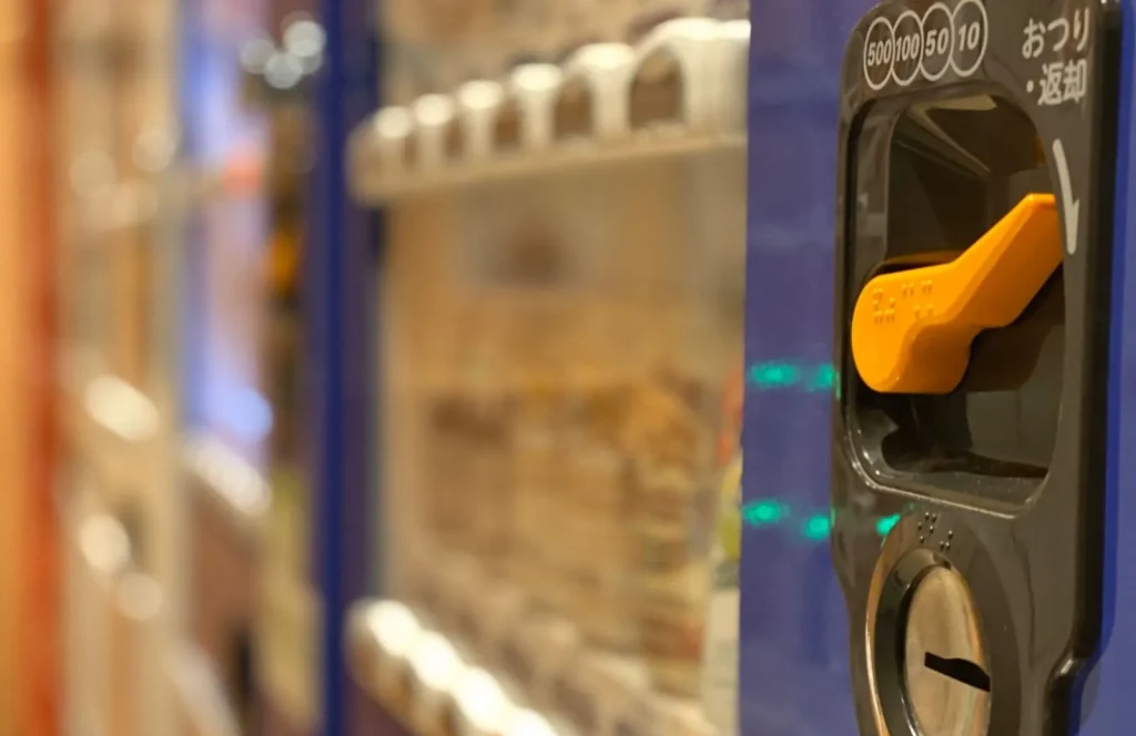 Image of various Japanese vending machines lined up on a street corner.