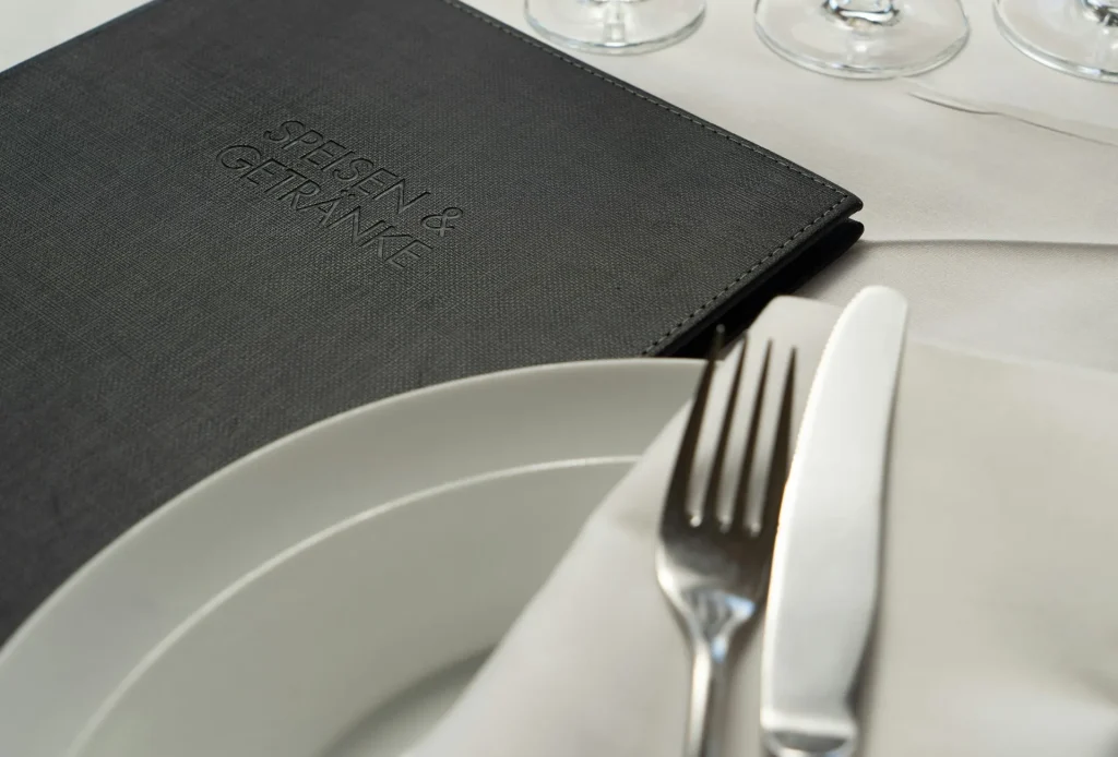 Image of a restaurant menu being consulted, emphasizing the need to check the menu thoroughly.