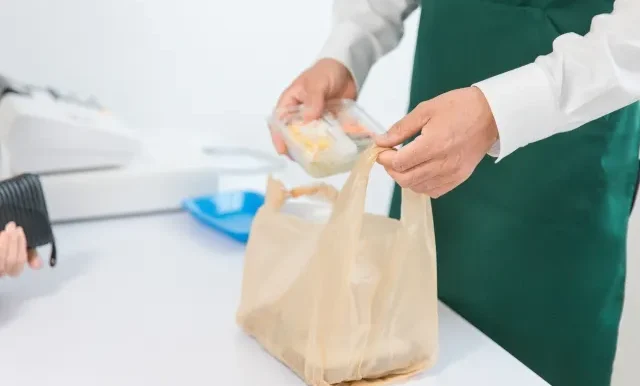 Image of a young foreign student working a part-time job as a waiter in a Japanese cafe.