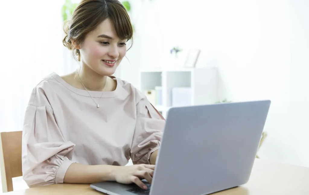 Image of a person using a wireless router and a laptop, symbolizing reliable internet connection.