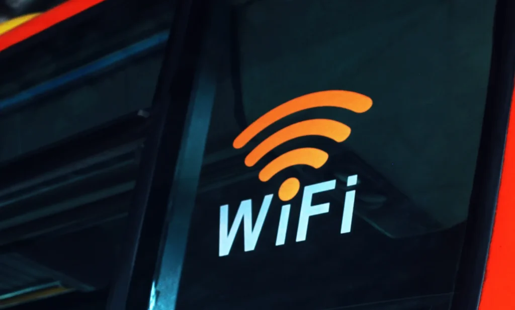 Image of a person using a smartphone on a Japanese street, illustrating portable internet access.