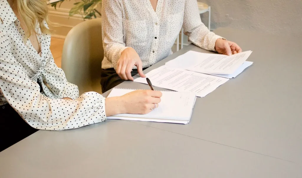 Image of a person reviewing a checklist of documents, symbolizing the necessary preparations for school enrollment.