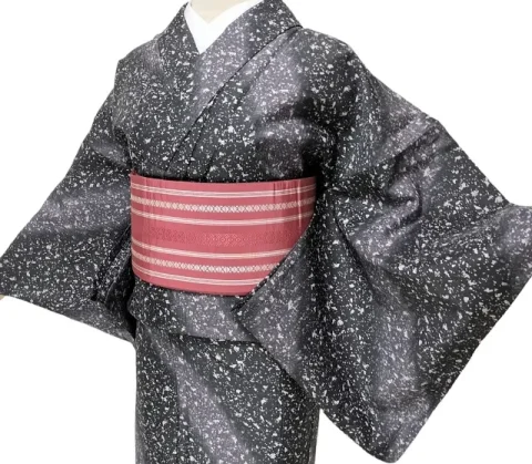 Image of a woman wearing a Komon kimono, characterized by small, repeating patterns all over.