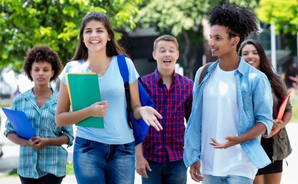 Image of children from diverse backgrounds studying together in a bright, modern classroom.