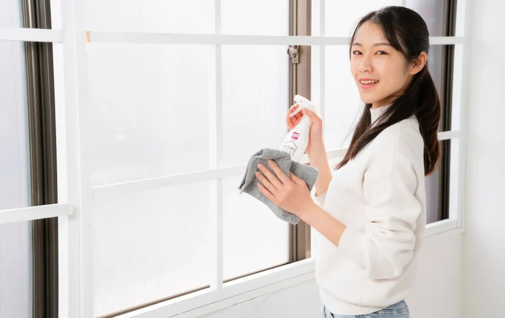 Image of a professional cleaner organizing a closet in a home.