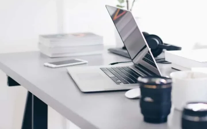 Image of a sleek, modern co-working space interior with comfortable seating and open workstations.