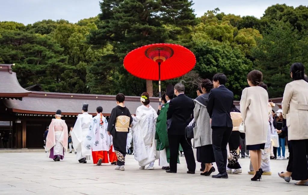 Image of a traditional Japanese wedding ceremony where the bride and groom are in formal kimono.