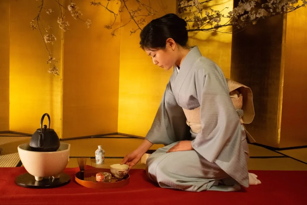 Image of a Japanese calligraphy artist wearing a kimono while writing.